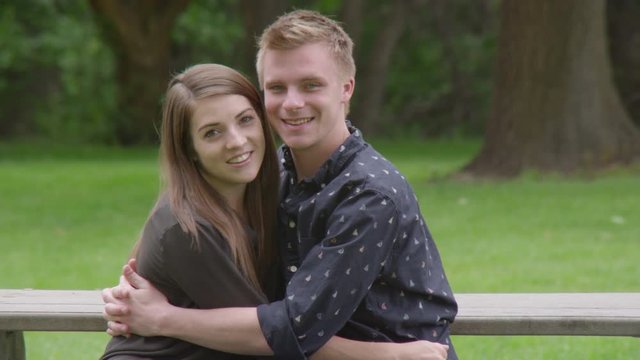 Portrait of young couple hugging in the park
