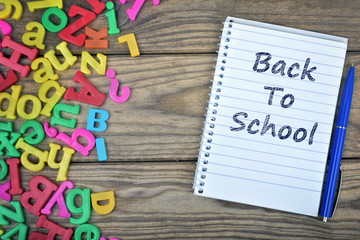 Back to School text on notepad and magnetic letters
