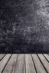 Old wooden table in front of black chalkboard vintage wall. Blac
