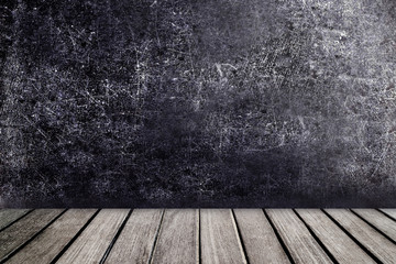Old wooden table in front of black chalkboard vintage wall. Blac