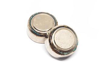 small watch rusty batteries isolated on white background