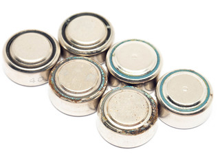 small watch rusty batteries isolated on white background