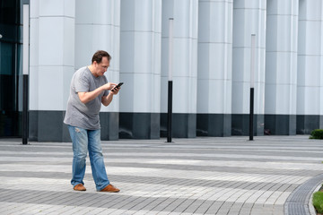 Man playing mobile game at the modern city background