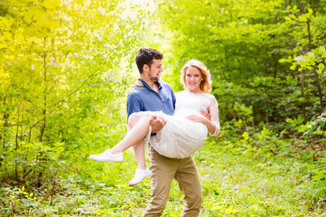 Fototapeta premium Beautiful wedding couple outside in green forest.