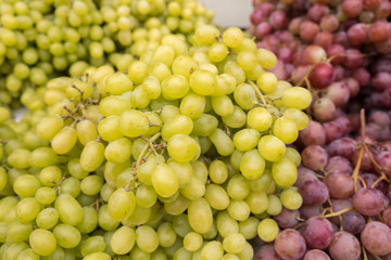 Green-yellow and red grapes for sale at city farmers market