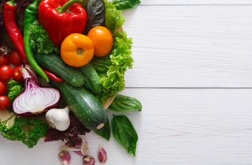 Border of fresh vegetables on wooden background with copy space