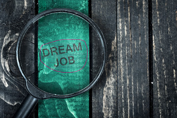 Dream Job text painted and magnifying glass on table