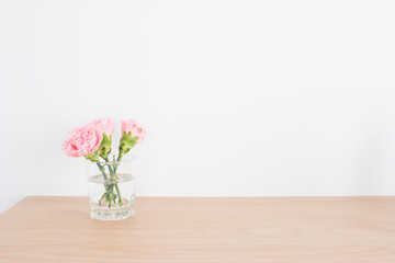 Pink carnations in the vase and blank easel