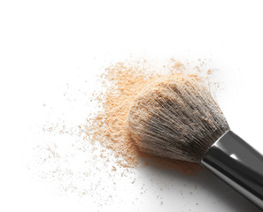 Make up brush and beige eye shadows on white background