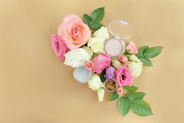 Eye shadows and flowers on beige background
