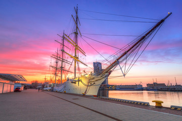 Fototapeta na wymiar Sailboat in Gdynia harbour at sunset, Poland