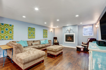 Pastel blue walls in basement living room interior.