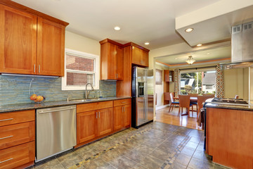 Kitchen interior with tile flooring and brown cabinets