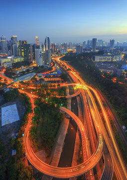 High angle view of illuminated road and city at night