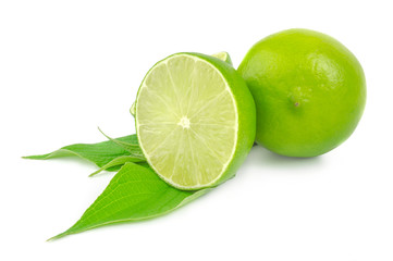 half and whole lime isolated on white with leaves