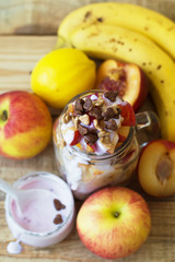 Vertical photo of fruit mix blended with yogurt and chocolate corn flakes, top view