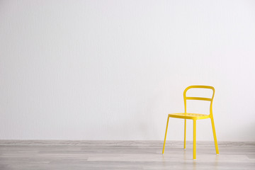 Yellow chair in light room interior
