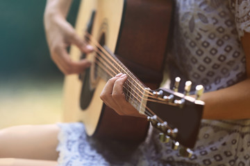 Fototapeta premium Beautiful woman playing guitar