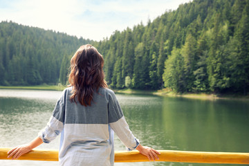 Girl on mountain lake background