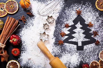 Obraz na płótnie Canvas Christmas tree made from flour on a dark table, ingredients for