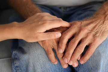 Old male and young female hands, closeup