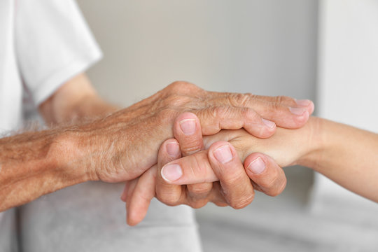 Old male and young female hands, closeup