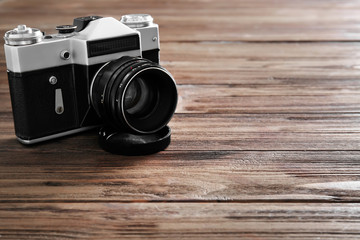 Vintage photo camera on wooden table