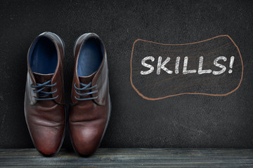 Skills text on black board and business shoes