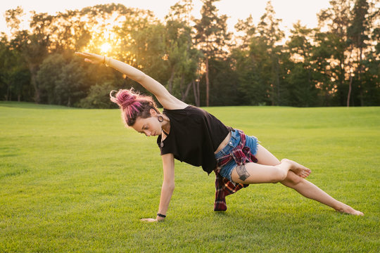 Woman With Dreadlocks Doing Yoga Exercises Outdoors