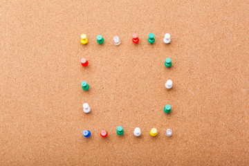 Pins on brown cork board