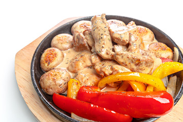 Isolated chicken with vegetable on frying pan