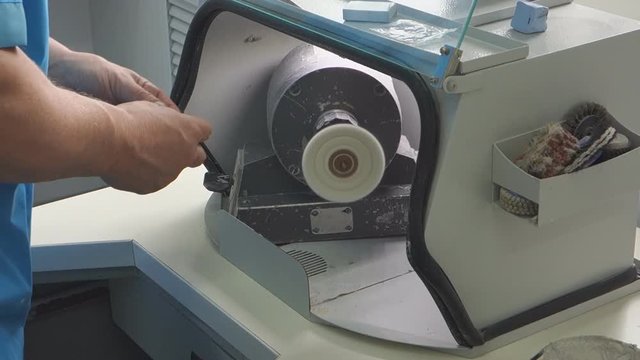 Stump dentist treats a nylon denture in the dental lab