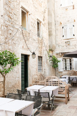 Fototapeta na wymiar Outside tables of the restaurant in medieval Kotor, Montenegro