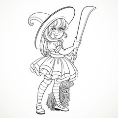 Cute little girl dressed as witch with a broom standing on a whi