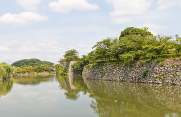 Fototapeta na wymiar Moat and stone walls of Himeji castle, Japan. UNESCO site