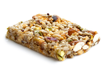 Fruit, nut and seed bar with pistachios isolated on white.