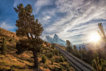 Papier Peint photo Cervin Matterhorn peak with railway against sunset in Swiss Alps, Switzerland