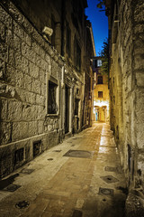 Fototapeta na wymiar Narrow cobbled street in old town at night, France.