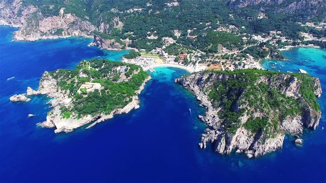Flight over Paleokastritsa bay Greece Corfu aerial 4k panoramic travel video. Resort, ocean sea coast, clean blue water, rocky cliff shore