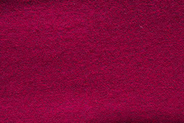 Close up crimson woollen knitted fabric texture. Loden background