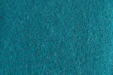 Close up cyan woollen knitted fabric texture. Angora background