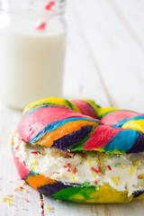 Colorful bagel with cheese and sprinkles and milk

