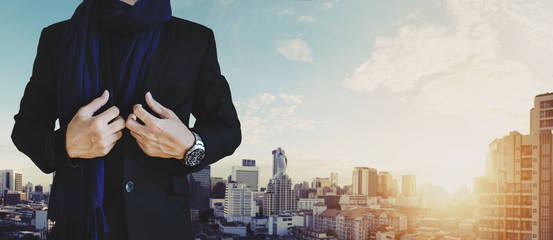 Businessman in casual suit with cityscape view in sunrise background