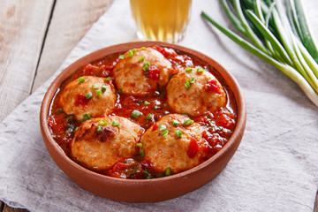 meatballs with tomato sauce in a clay bowl
