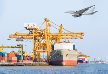 Container cargo freight ship with working crane loading bridge 