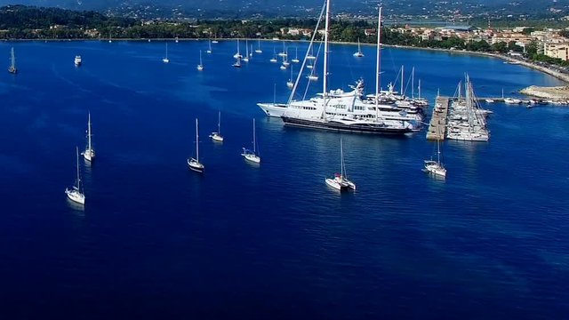 Corfu Marina harbor with yachts boat ship Greece island aerial HD video. Garitsa Bay sea ocean coast, old city