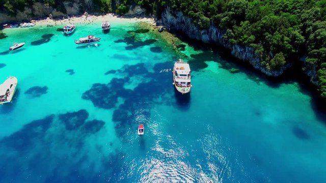Tropical Ionian Greece island aerial 4k travel video. Yacht boat on blue water in ocean sea harbor bay, forest coast seashore, marina