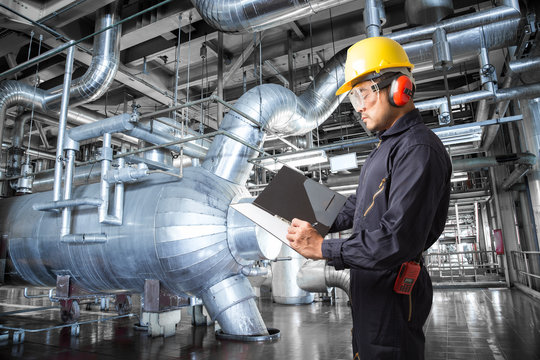 Engineer taking notes at thermal power plant factory