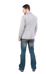 back view of Business man looks. guy in a gray jacket looking sideways.