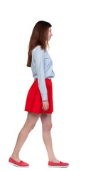 back view of walking woman. Isolated over white background.
